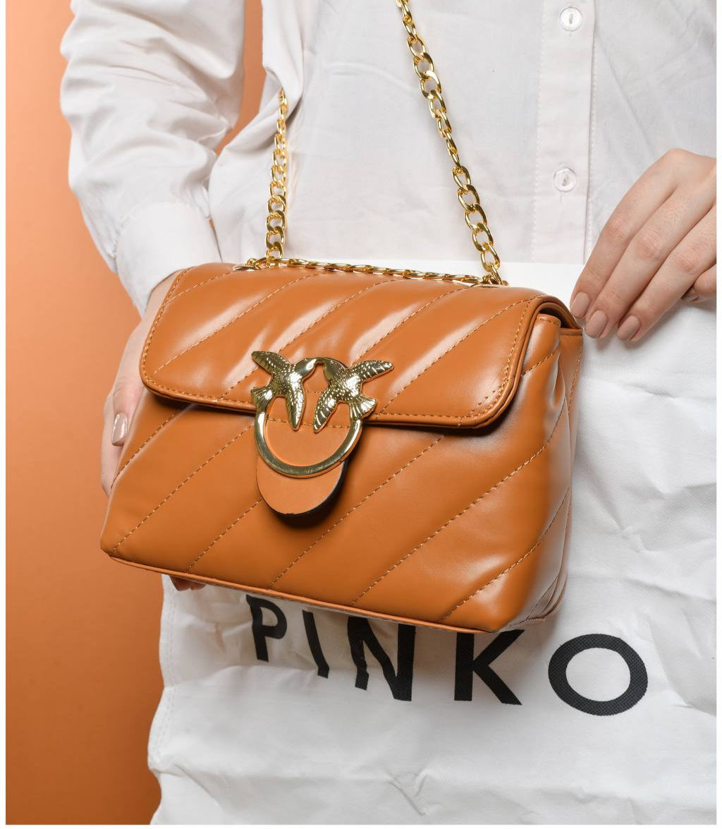 gold accessorized trendy bag